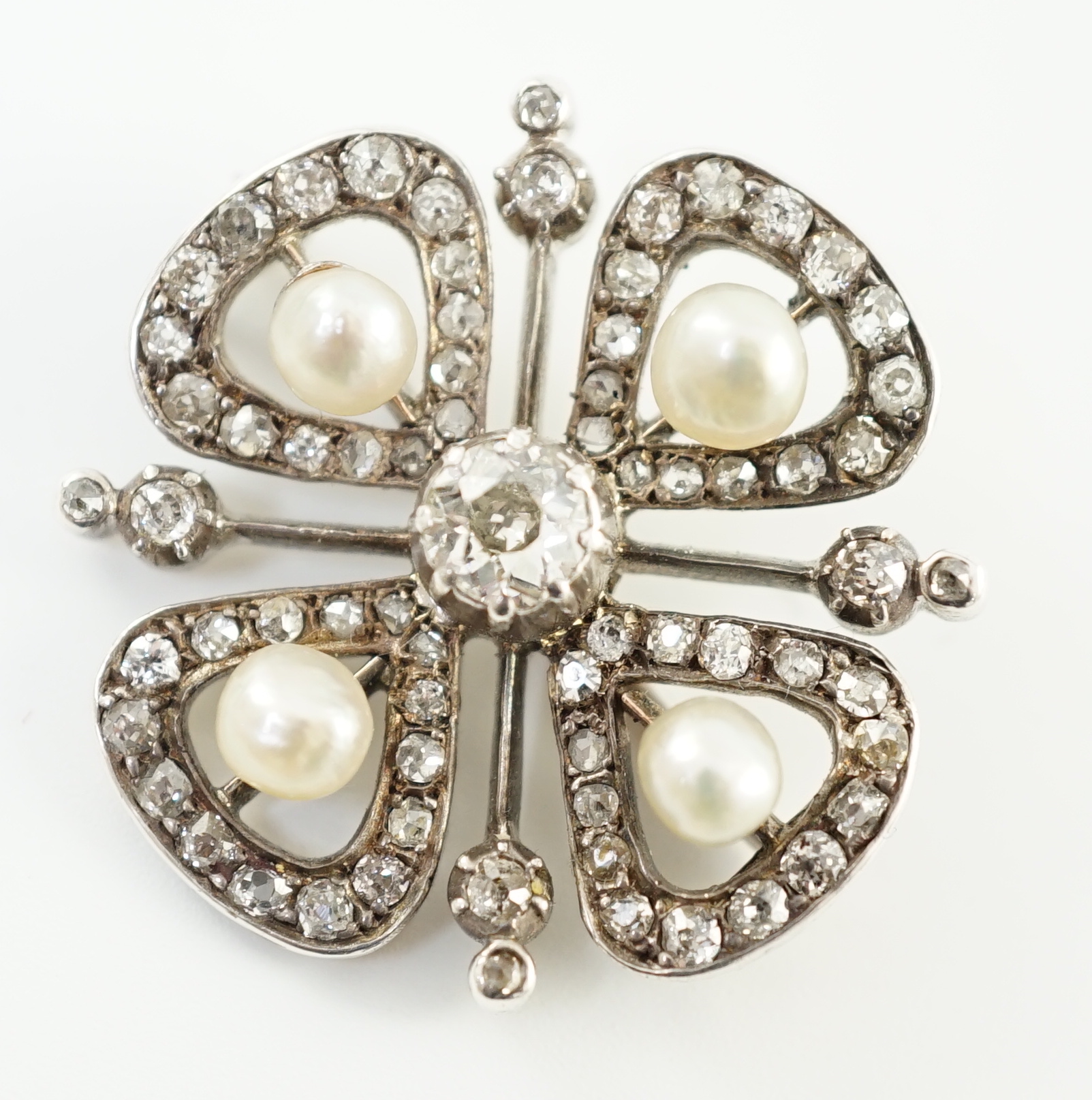 An Edwardian gold and platinum, diamond and four stone button pearl cluster set 'clover' brooch